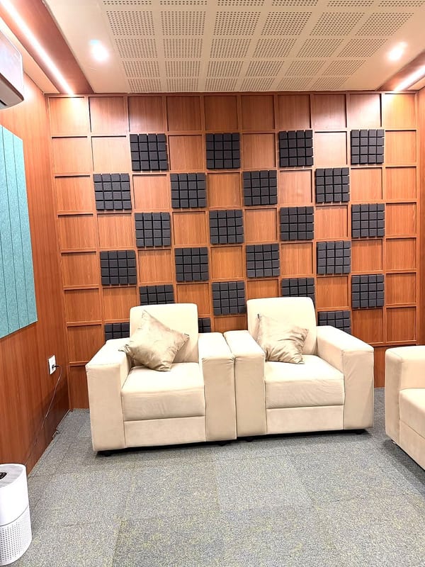 Podcast studio with acoustic panels and lounge seating